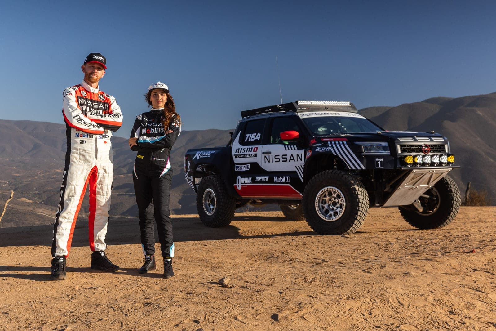 Chris Forsberg and Emelia Hartford beside the No. 7164 Nissan Frontier at the NORRA 500
